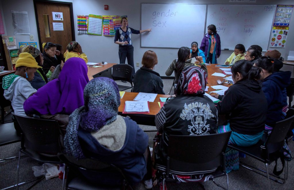 A group of refugees attending an ESL class at their local resettlement office