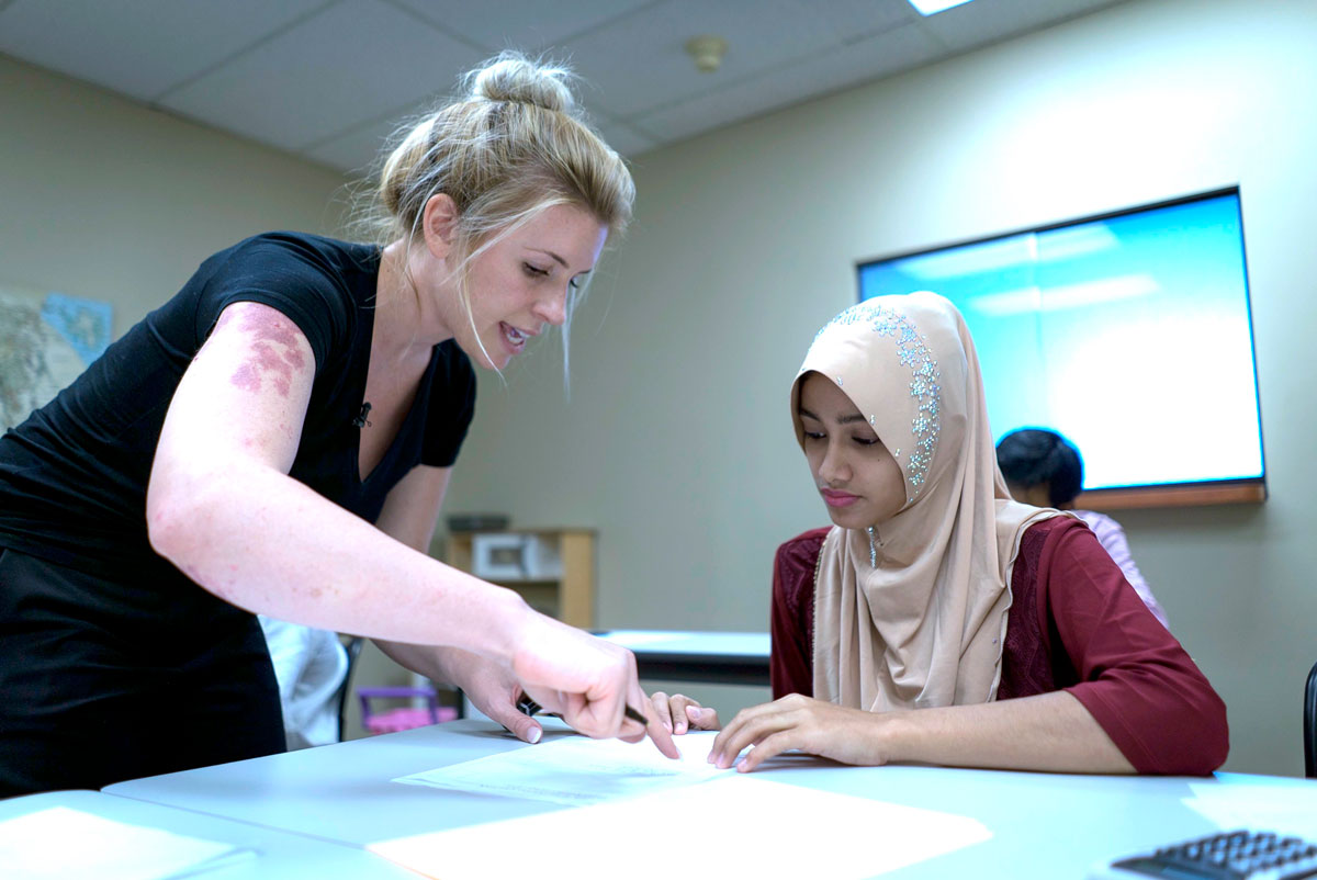 Burmese refugees learning about financial literacy from a cultural orientation provider