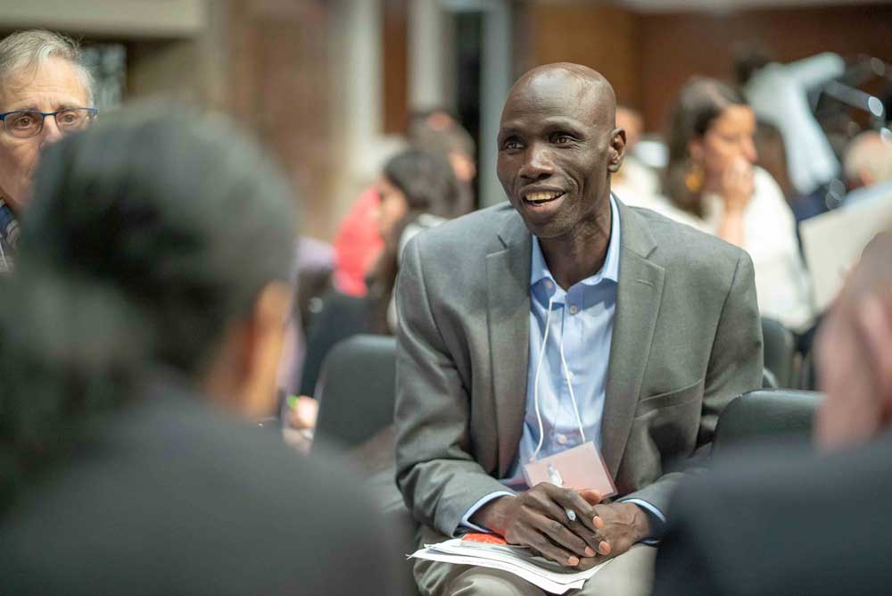 A Sudanese refugee speaking with U.S. political representatives about his story and advocating for support for refugee resettlement