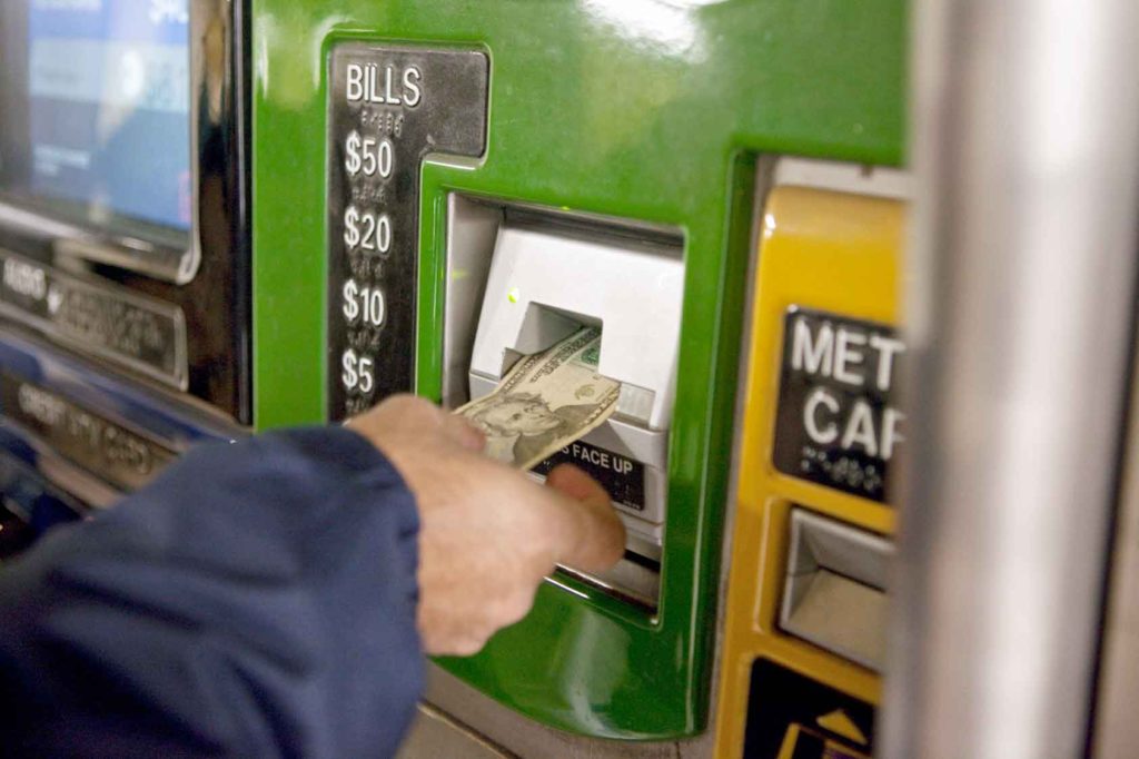 A recently resettled refugee learning how to buy a subway ticket