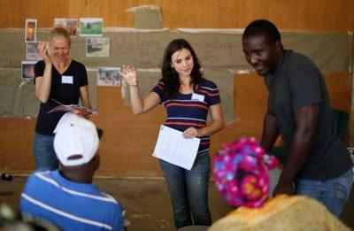 A group of volunteers teaching recently resettled refugees about community farming