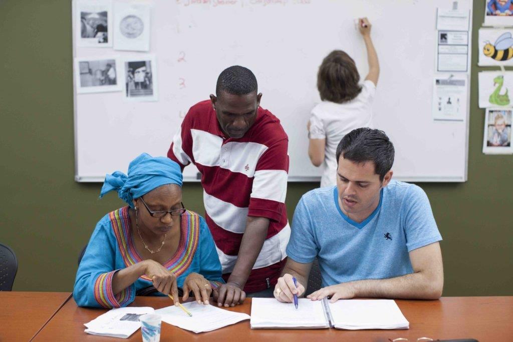 A group of refugees learning together during a cultural orientation class at their local resettlement office. IRC/Harkin