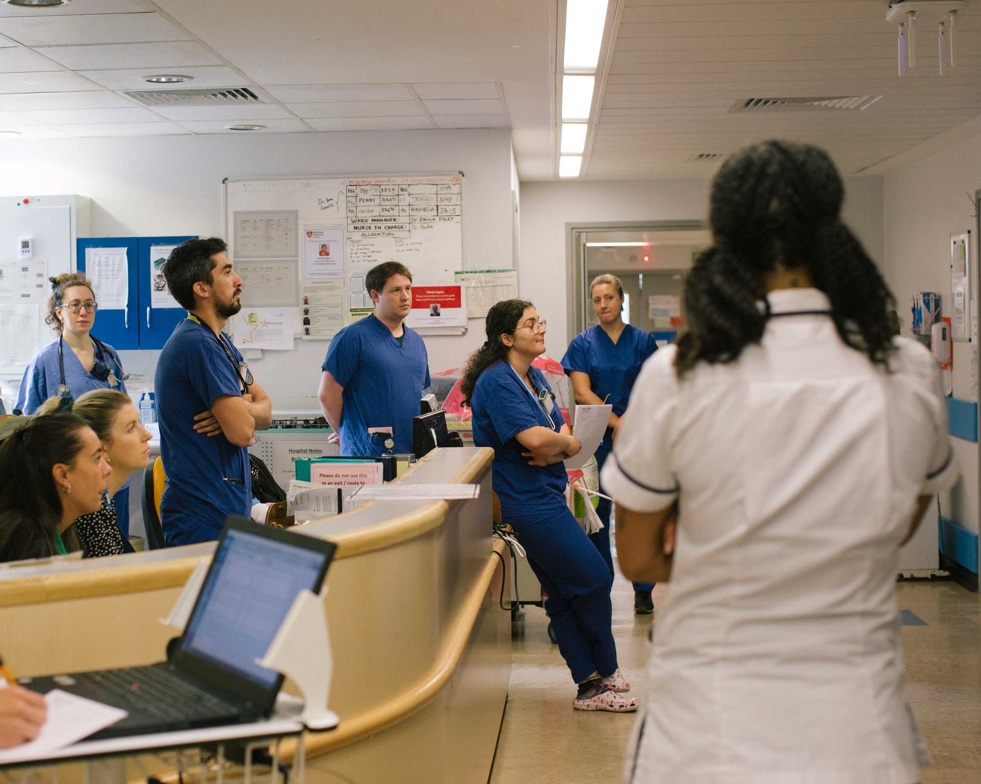 A group of nurses and doctors standing together during a meeting. IRC/EHeatherwick
